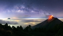 This planet we live on its pretty darn incredible This is a  image panorama of the Milky Way rising just before sunrise as Vulcn de Fuego erupts with an explosion of lava On the left side of the frame that is Vulcn de Agua