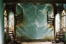 Twin Spiral Staircases in a blue decaying room Persian Villa 
