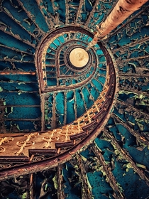 Upwards view of a beautiful spiral staircase in decay 