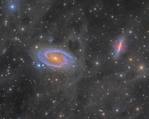 Using  hours of exposure I was able to reveal the swirling clouds of dust surrounding two galaxies 