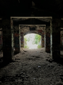 View from the very dark back wall of one of the abandoned Rutland Prison Camp structures in Massachusetts
