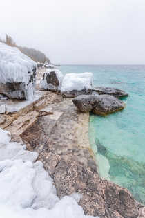 When frozen ice and snow meet tropical looking waters Bruce Peninsula Canada 