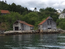 Withering boat houses in a Norwegian fjord