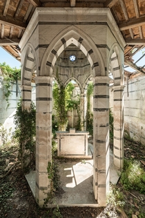 Wonderful abandoned Italian chapel overgrown with ivy plants 