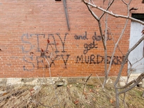 Words to live by written on the side of an abandoned sanitarium in New England