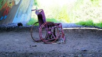 Wrecked spraypainted wheelchair in highway underpass near Helsinki 